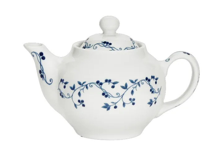 A white ceramic teapot decorated with blue vine and berry patterns.