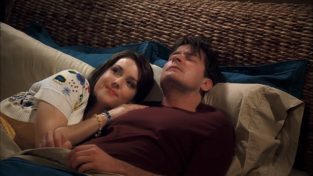 Melanie Lynskey as Rose and Charlie Sheen as Charlie Harper lying in bed together in a scene from 'Two and a Half Men'.