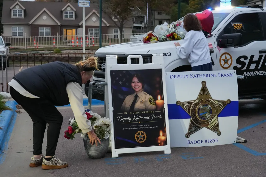 Mourners bring bouquets of flowers to honor the life of Deputy Katherine Frank on Tuesday, Oct. 13, 2026, at the Police Law Enforcement Center in Sioux Falls, SD.