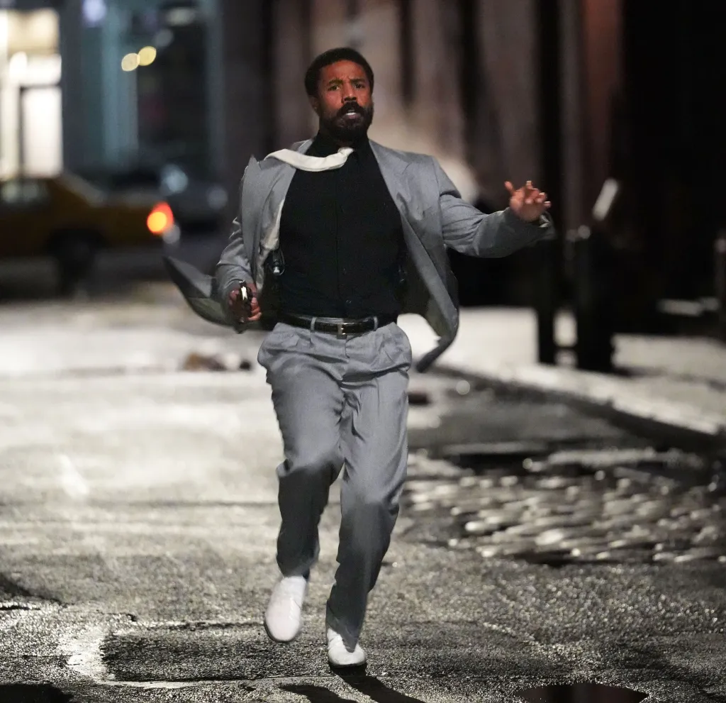 Michael B. Jordan runs through a street at night while filming 