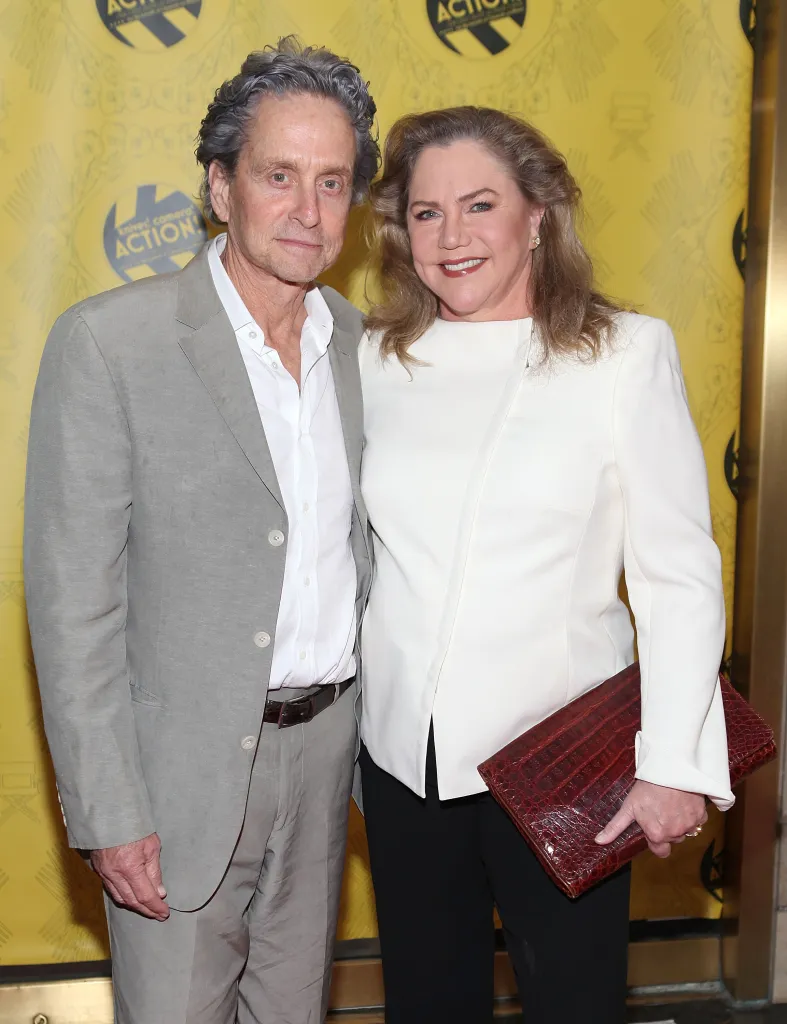 Michael Douglas and Kathleen Turner posing together at an event.