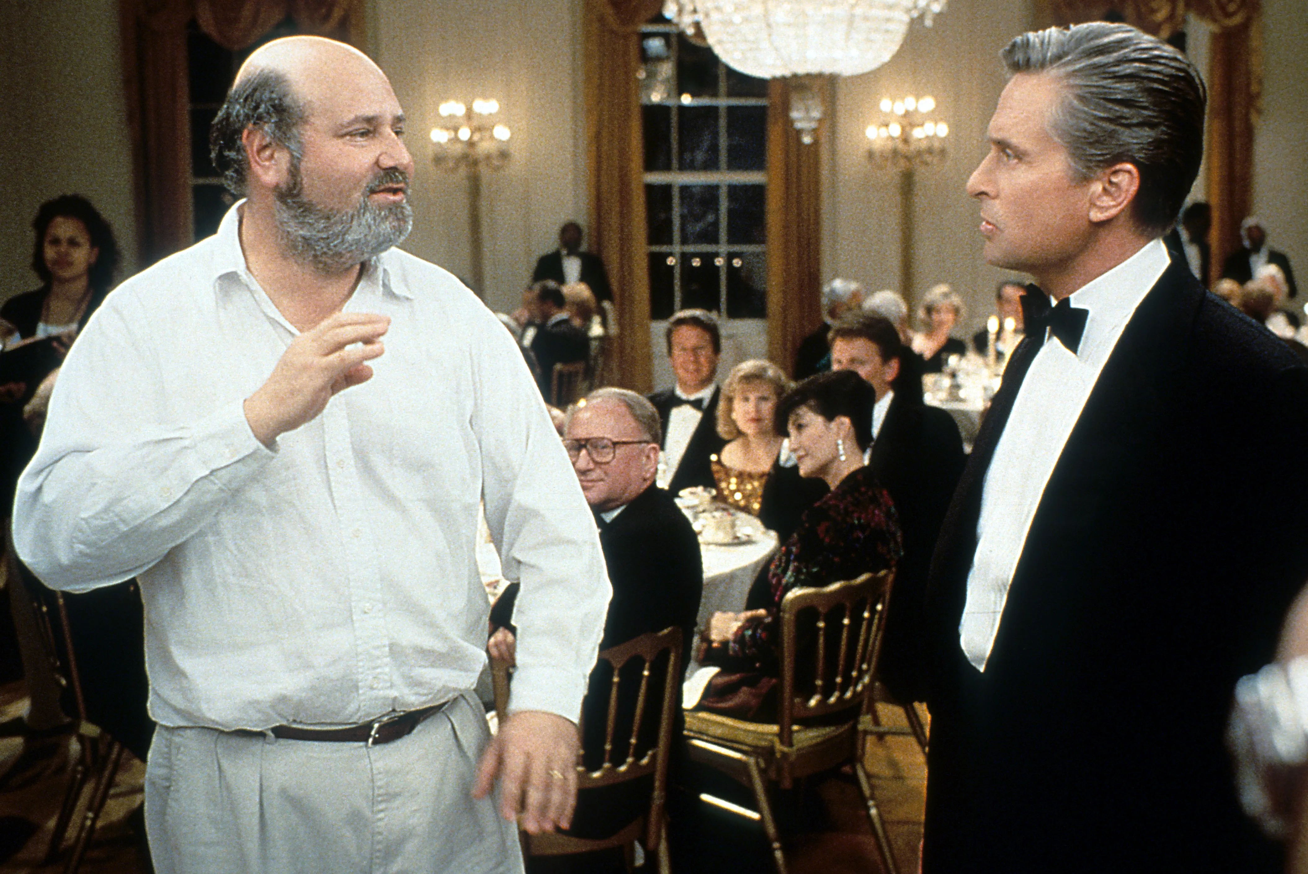 Michael Douglas listens to Director Rob Reiner in between scenes from the film 'The American President'.