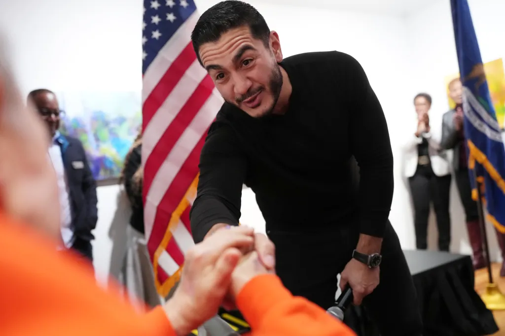 Michigan Democratic Senate candidate Abdul El-Sayed shakes hands with an audience member at a campaign event.