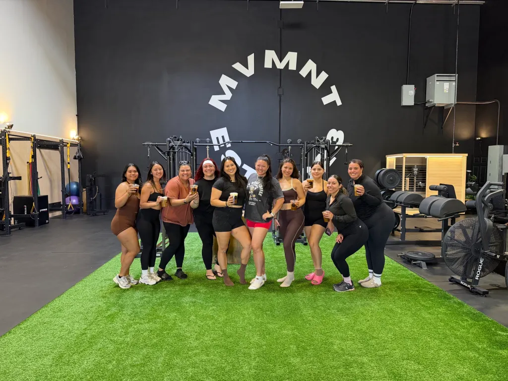 Jenny Voo poses in the center with friends in a gym.