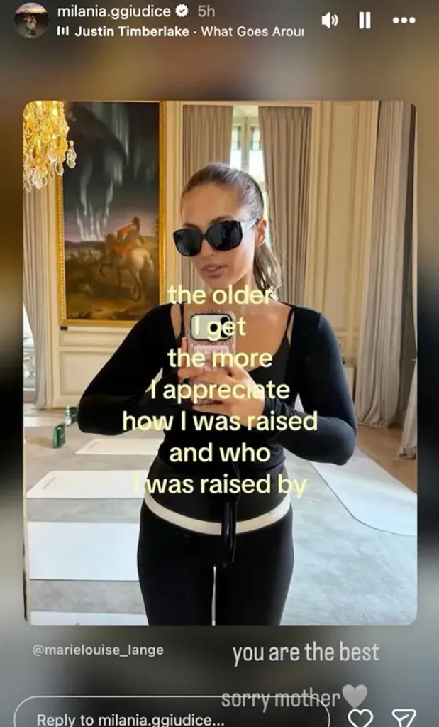 Milania Giudice wearing sunglasses and taking a mirror selfie in a room with a large painting, with text overlay reading, 
