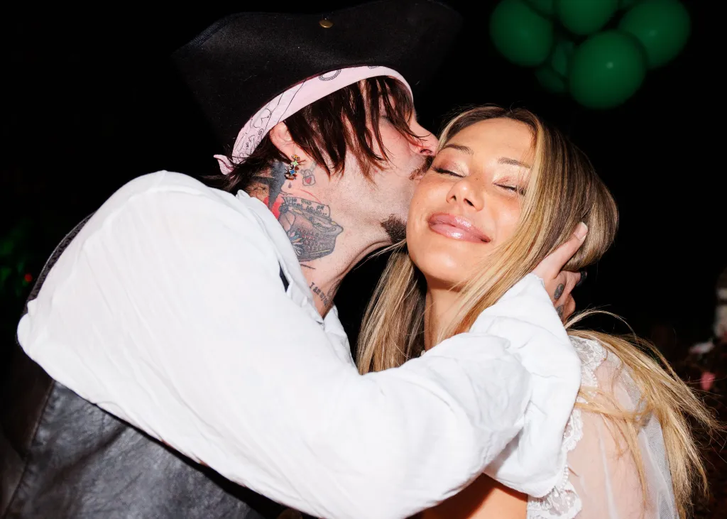 Mod Sun kisses Sahara Ray on the cheek.