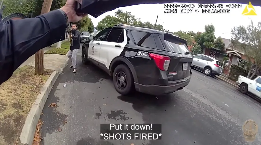 Bodycam footage shows a man holding a pole saw charging toward police officers near a patrol car.