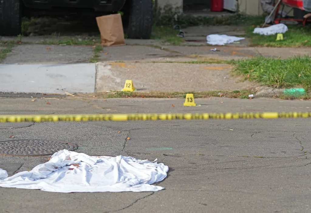 Evidence markers are scattered across the road after the deadly mass shooting on Oct. 9, 2026.