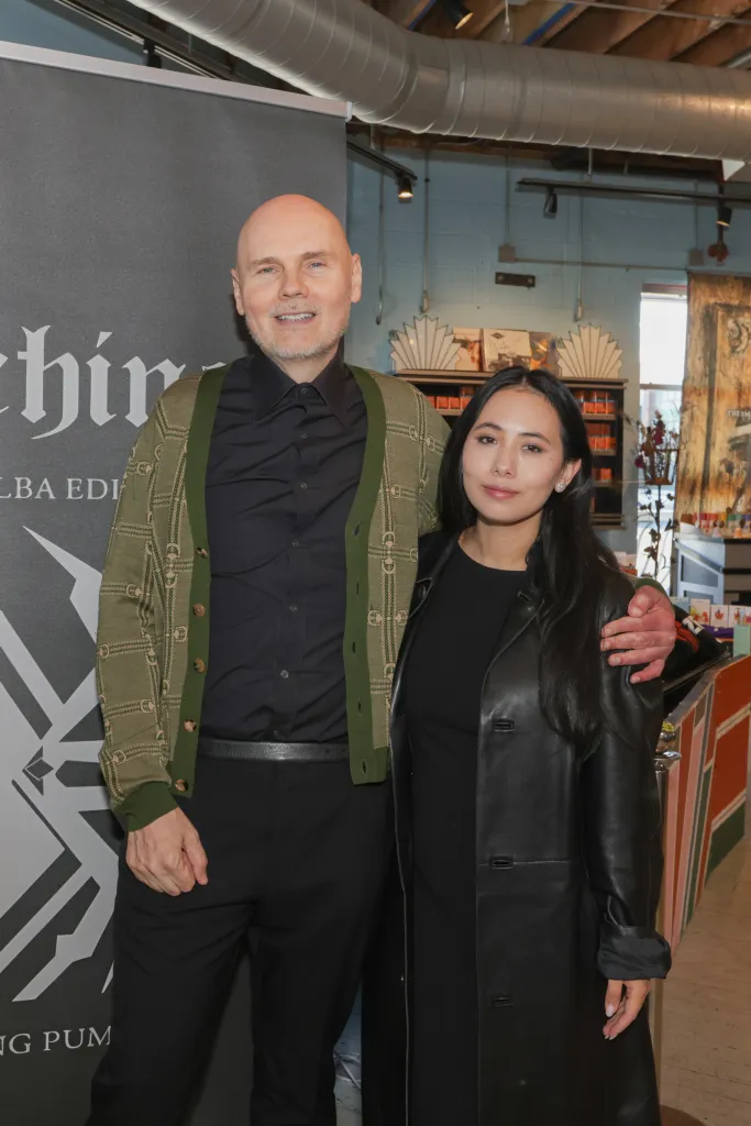 Musician Billy Corgan and wife Chloe Mendel pose together.