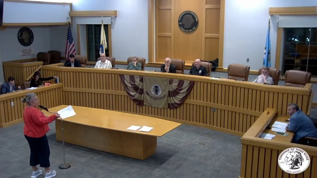 Toms River resident Dana Tormollan argues with Mayor Daniel Rodrick over a letter sent to her in the mail during the township council meeting on Oct. 19, 2026.