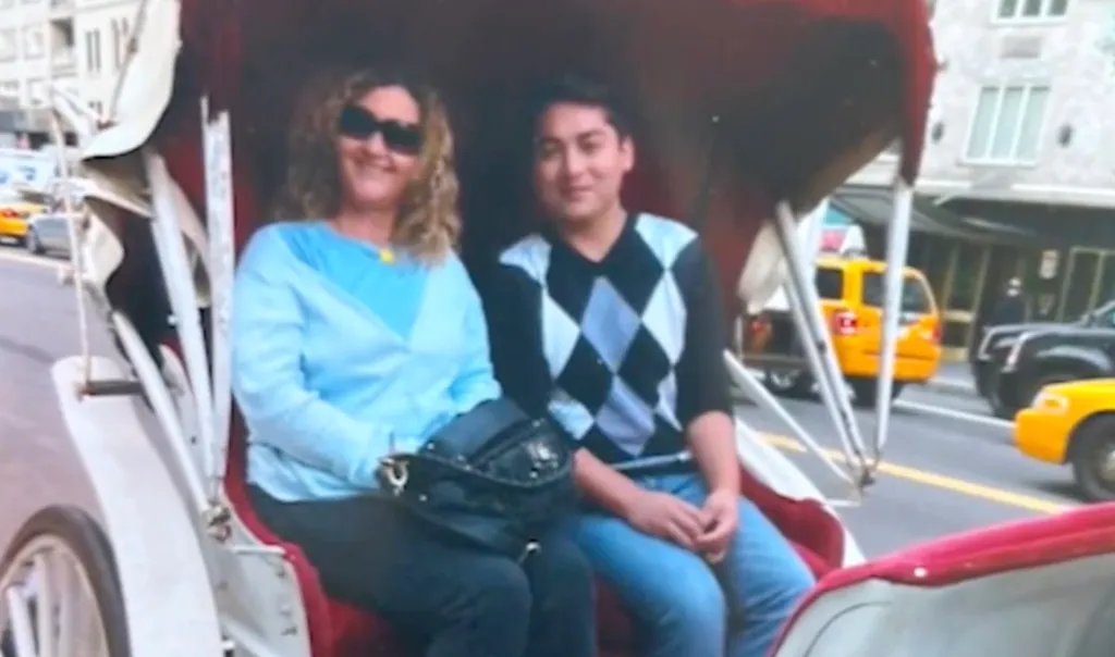 Nadine Jett and her foster son, Cedric von Ferdinand, sitting in a horse-drawn carriage on a city street.