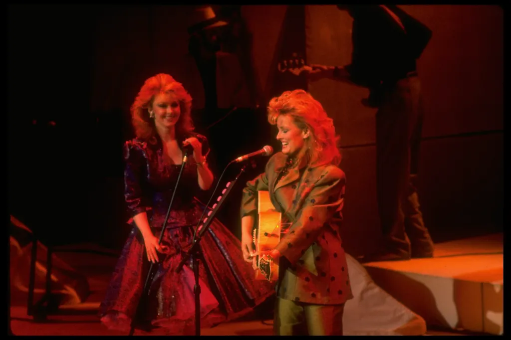 Naomi and Wynonna Judd performing on stage.