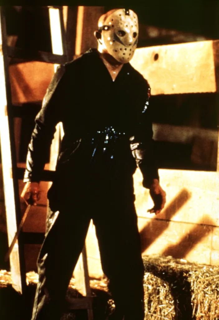 Ari Lehman as Jason Voorhees wearing a hockey mask in a scene from 