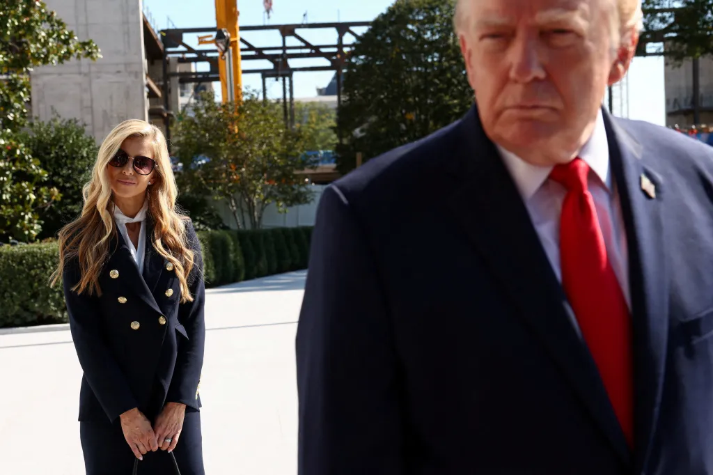 New White House Press Secretary Katie Zacharia stands behind U.S. President Donald Trump as he departs the White House.