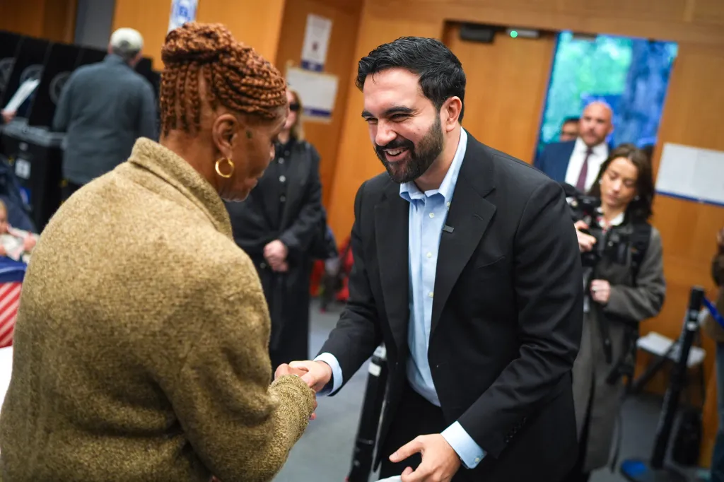 New York City Mayor Zohran Mamdani greets a poll worker at the Metropolitan Museum of Art polling site.