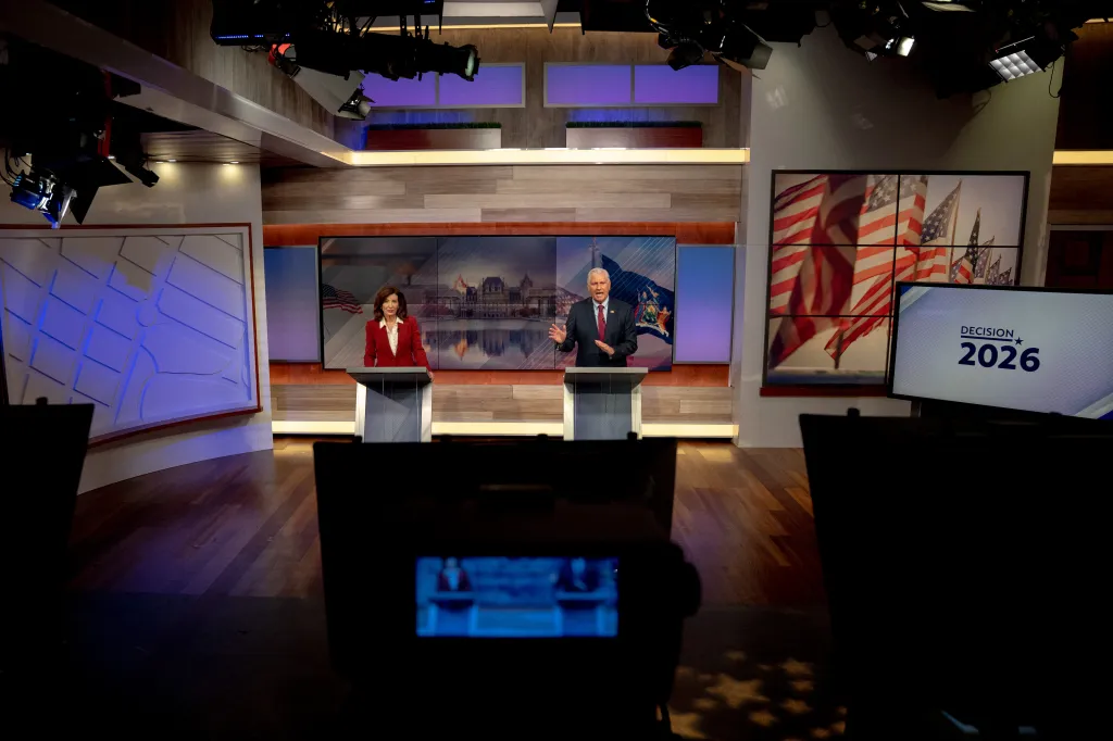 New York Governor Kathy Hochul and Republican candidate Bruce Blakeman at their podiums during a televised debate.