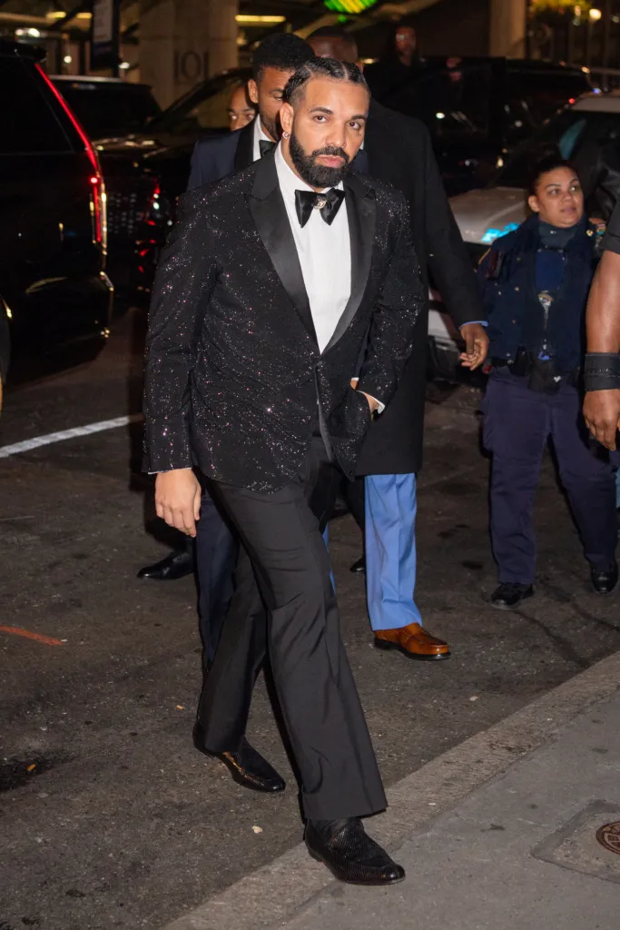 Drake arrives at Cipriani wearing a sparkling black tuxedo jacket and bow tie.