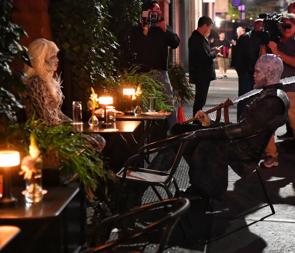 Jordyn Woods and Karl-Anthony Towns sit outside a New York establishment in Game of Thrones costumes.