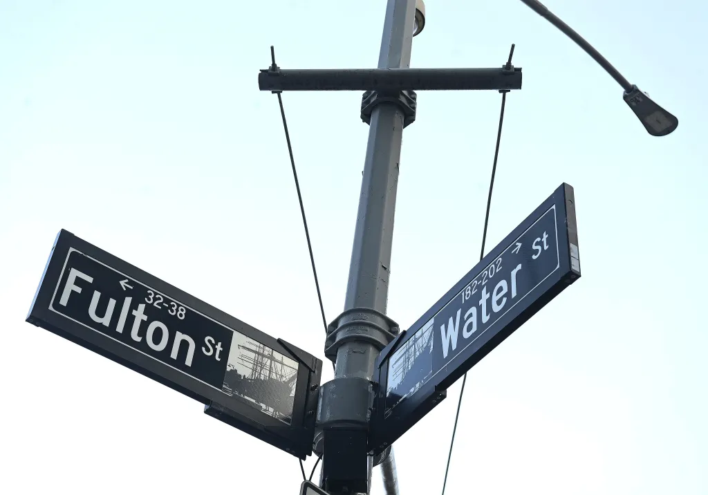A street sign marks the intersection of Water and Fulton streets at the South Street Seaport in New York.