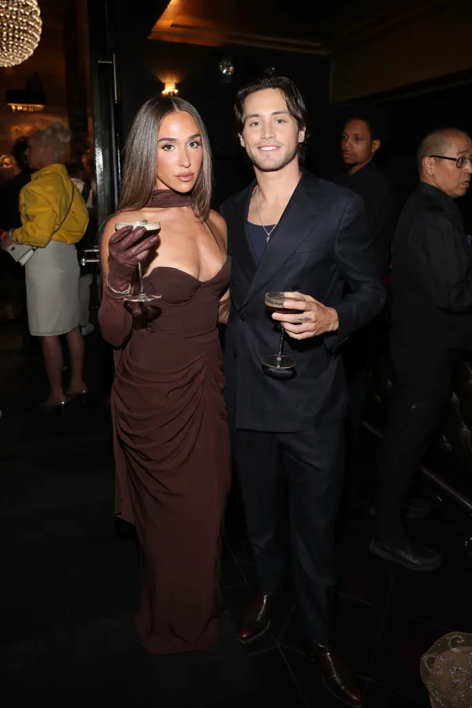 Ariana Biermann and Liam Obergfoll pose together while holding drinks at the Virtual Reali-Tea Awards.