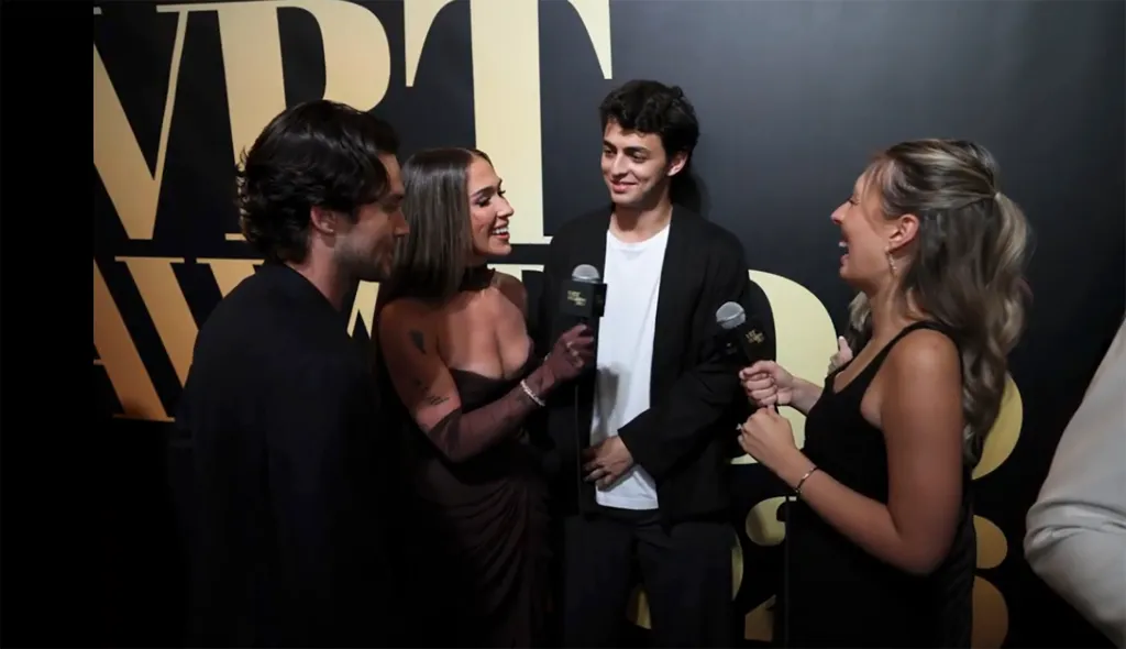 Ariana Biermann and Liam Obergfoll being interviewed on a red carpet.