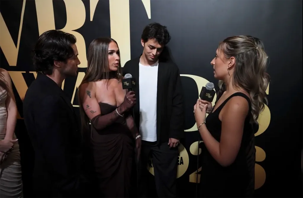 Next Gen: NYC stars Ariana Biermann and Liam Obergfoll being interviewed on a red carpet.
