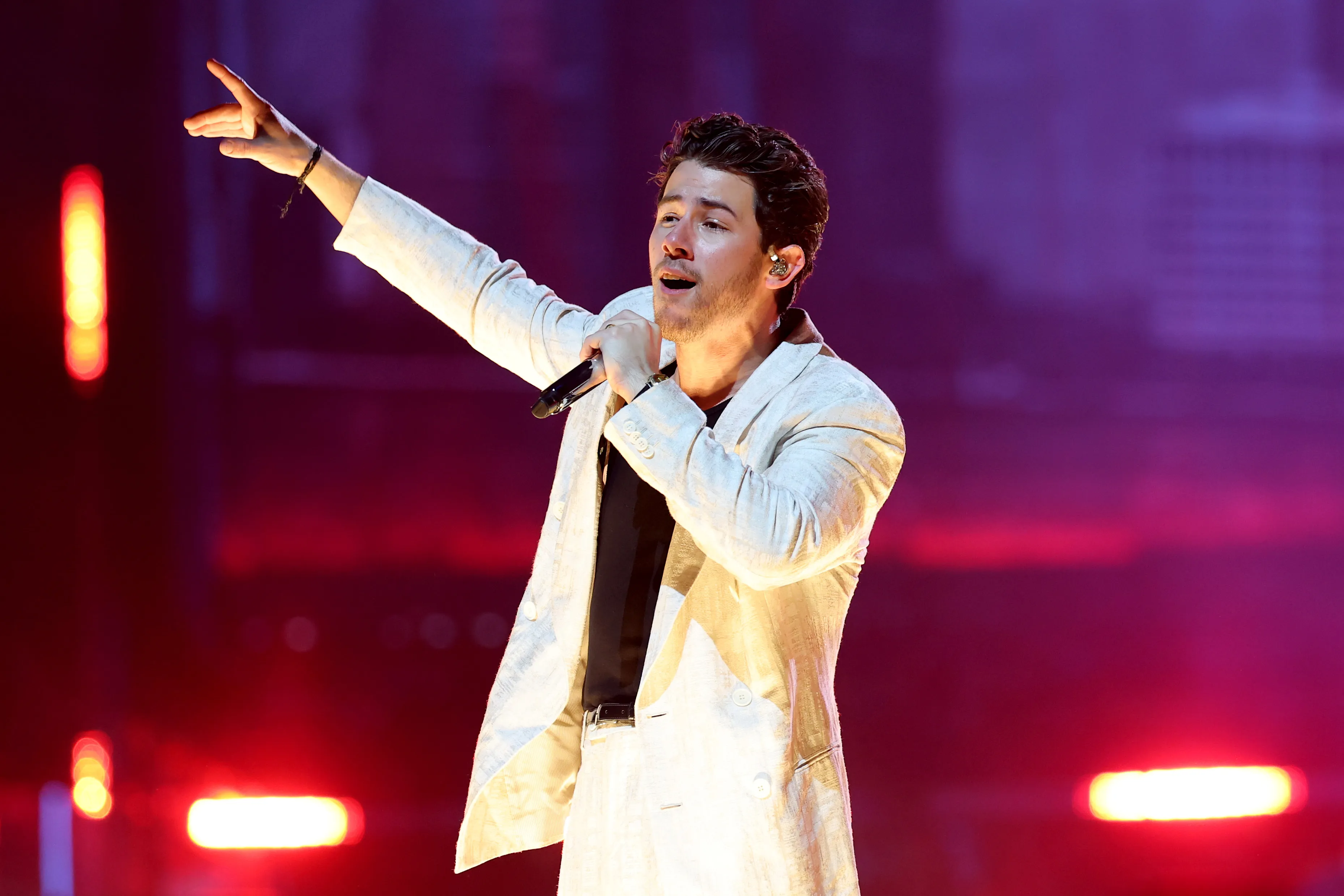 Nick Jonas performs on stage during a concert.