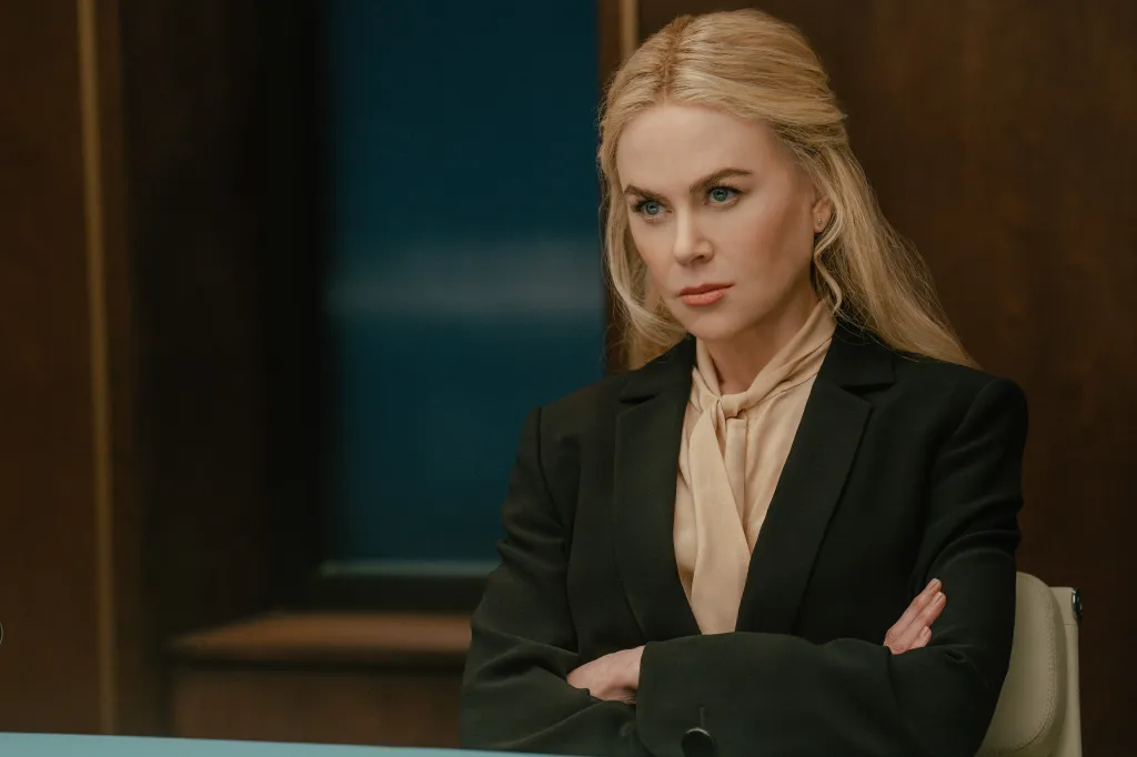 Nicole Kidman, in a black jacket and nude blouse, as Kaitlyn in Lioness, with her arms crossed, looking intently.