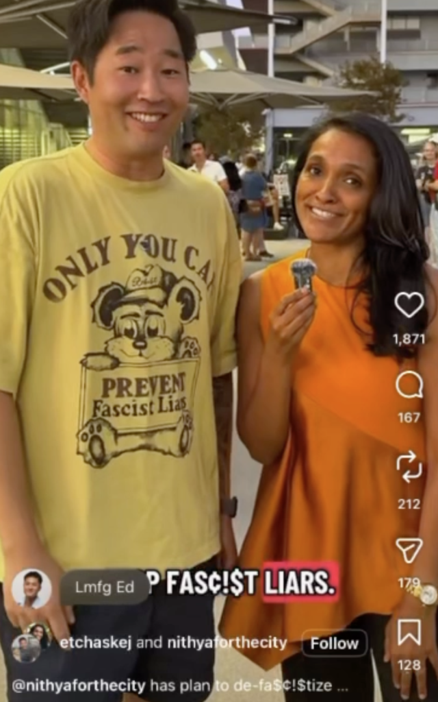 Los Angeles City Councilmember Nithya Raman stands next to a man wearing a shirt that says 