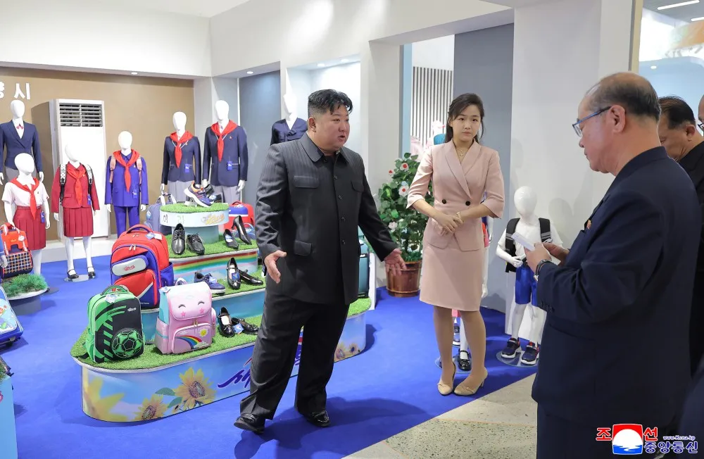 Kim Jong Un gestures animatedly while addressing officials at a garment and footwear exhibition in photographs released by North Korean state media.