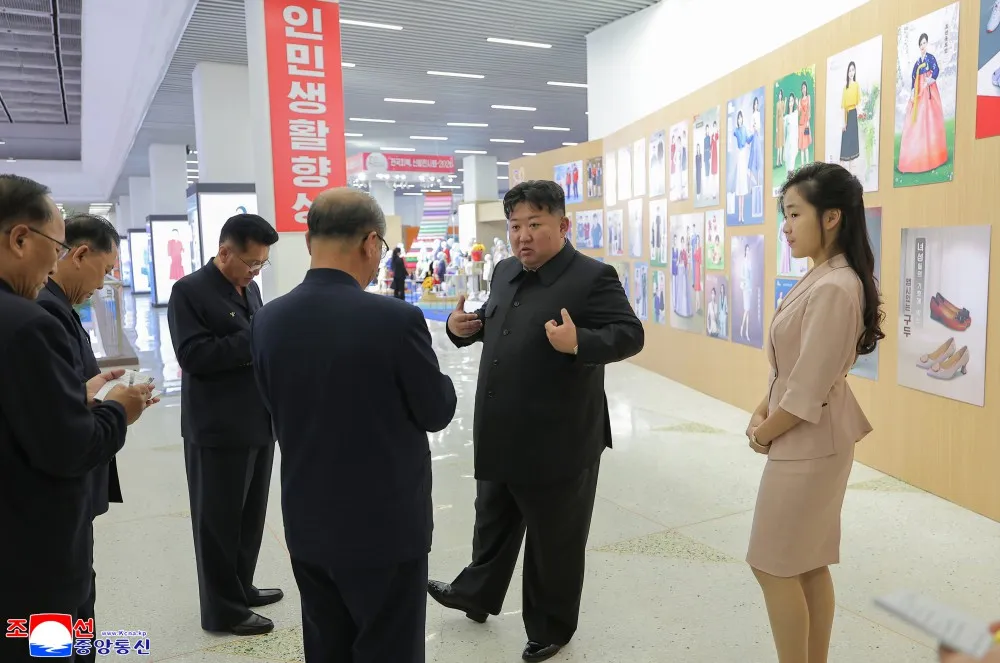 In this photo released Monday by the North Korean government, North Korean leader Kim Jong Un, accompanied by his daughter Ju-ae, looks around the venue of a garment and footwear exhibition.