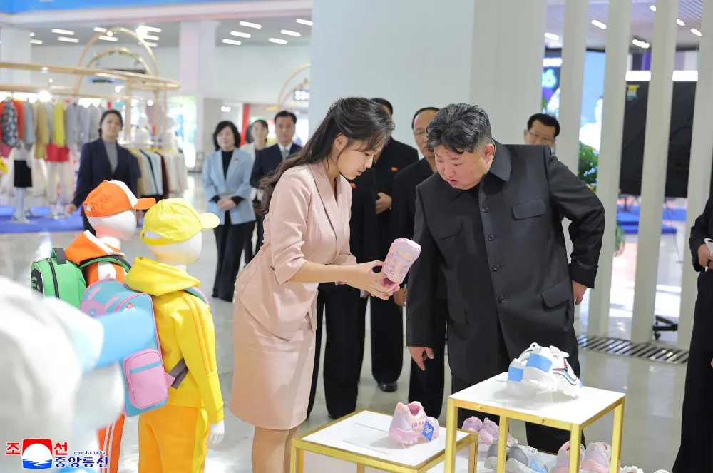 Kim Jong Un was pictured inspecting merchandise at a North Korean exhibition following unsubstantiated reports that he had fallen into a coma and died after being transferred to Beijing.