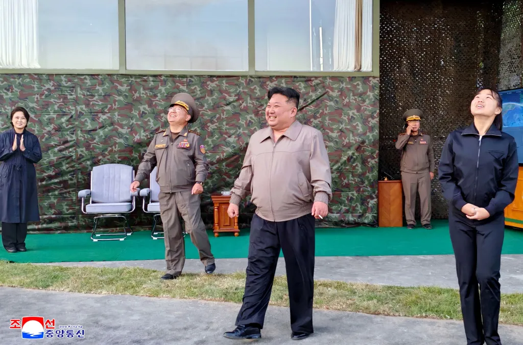 North Korean leader Kim Jong Un, left, accompanied by his daughter Kim Ju Ae, attends to oversee the firing of an intermediate-range missile from the eastern region of the country toward the East Sea during a drill in North Korea, on Oct. 3, 2026.