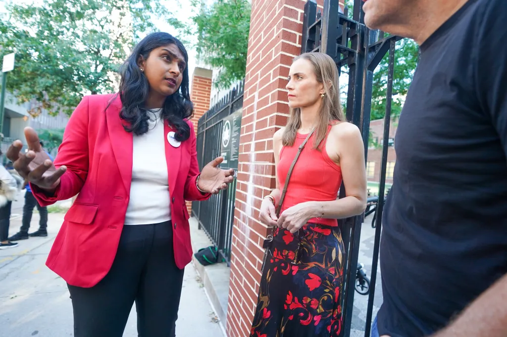 New York Attorney General candidate Saritha Komatireddy speaks with neighborhood residents outside a playground.