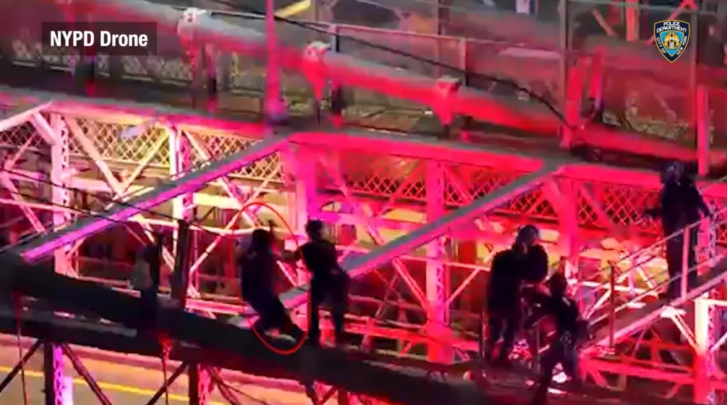 NYPD drone footage shows police confronting a knife-wielding man on the Brooklyn Bridge.
