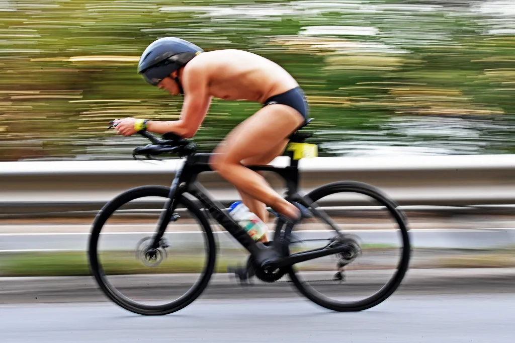 A competitor in the NYC Triathlon races on a bicycle.