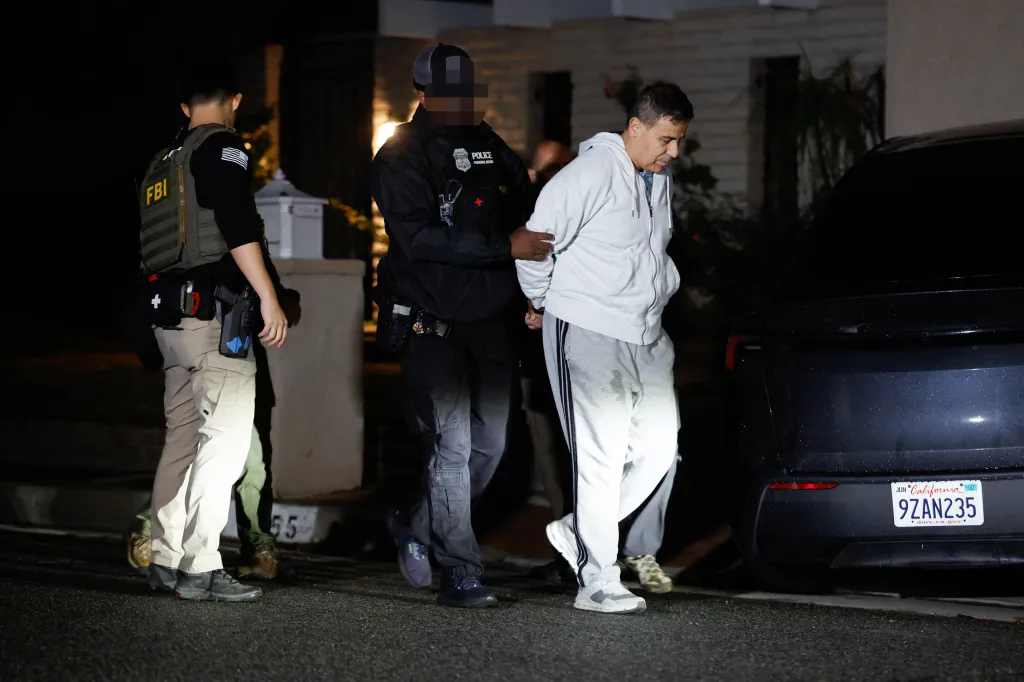 FBI agents arresting Hany Malek at his mansion in Tarzana, California.