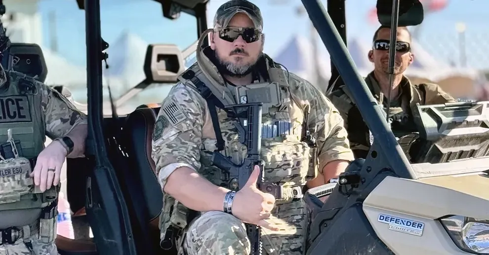 Officer Aaron Zaliponi in tactical gear seated in an all-terrain vehicle.