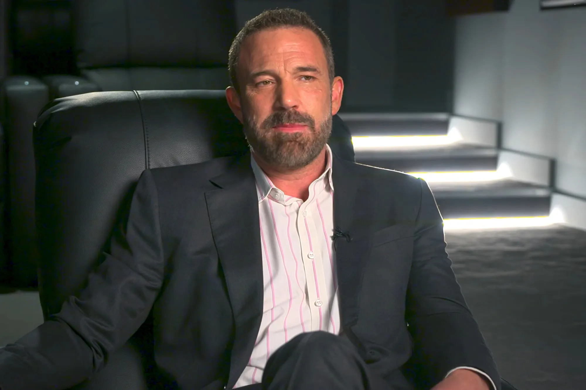 Ben Affleck sitting in a chair during an interview.