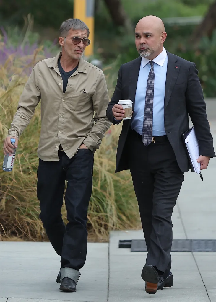 Olivier Martinez walks with his lawyer outside the Stanley Mosk Courthouse.