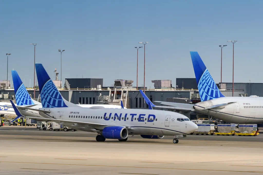 A United Airlines jet - white with blue writing