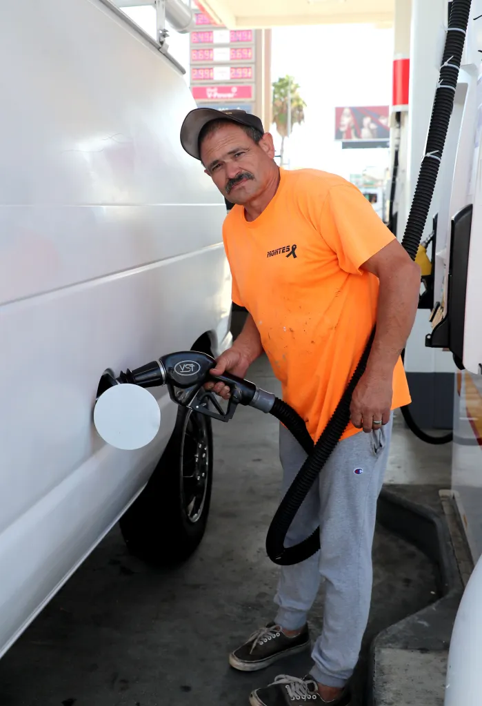 Oscar Montes pumps gas into his vehicle at a Shell gas station.