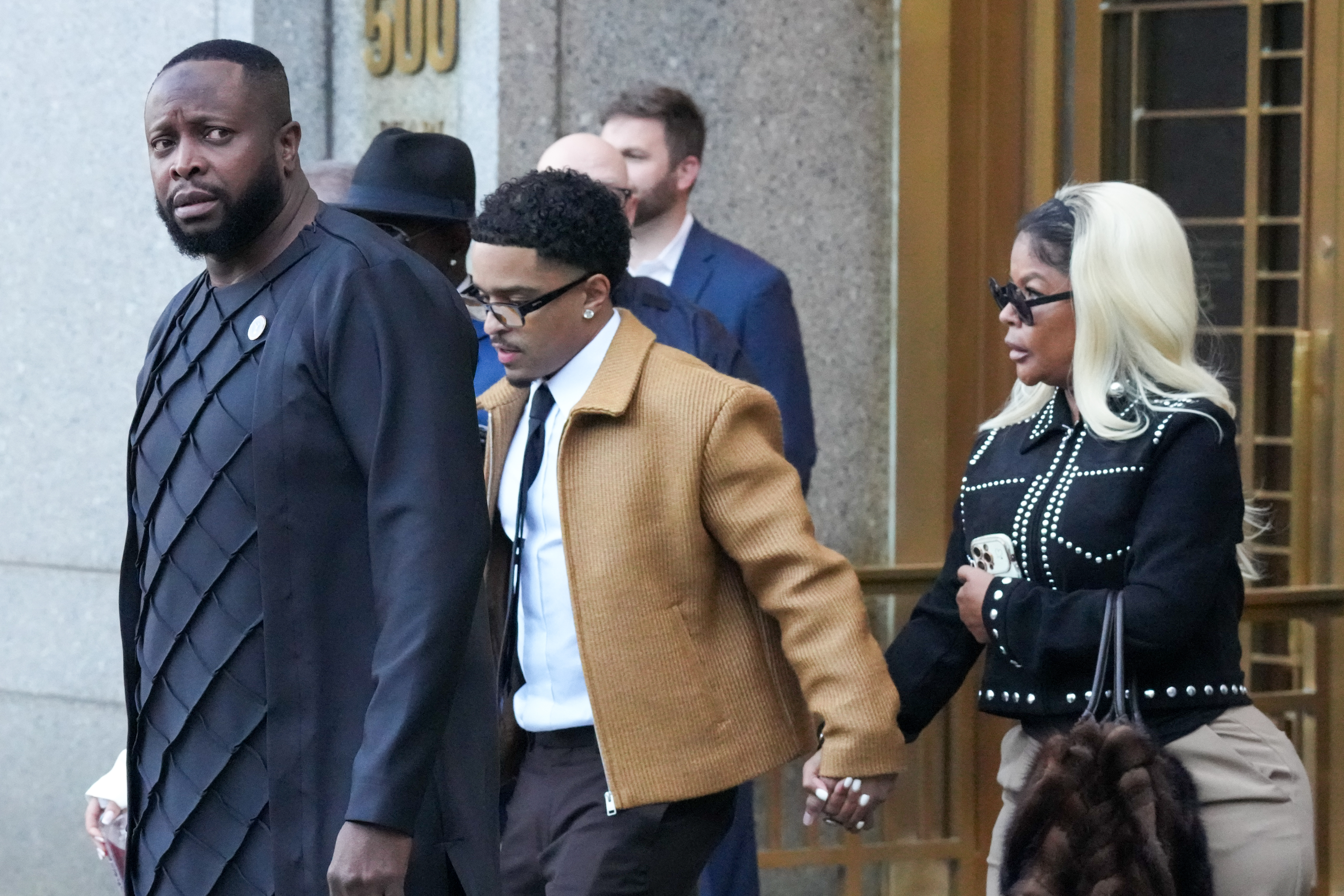 Family and friends leaving a courthouse.