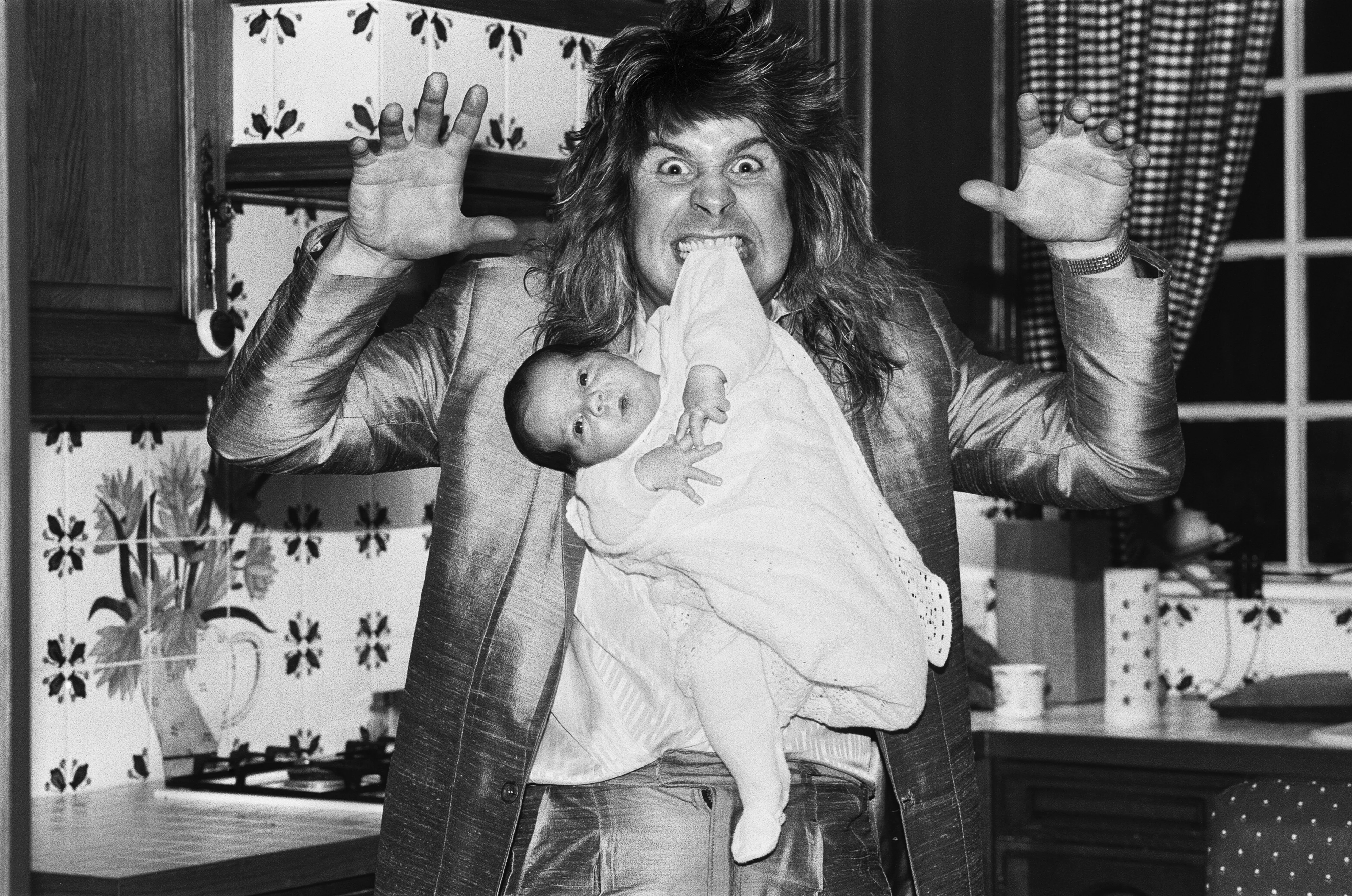 Ozzy Osbourne holds his son, Jack, by his teeth when he was just two weeks old on Nov. 25, 1985.