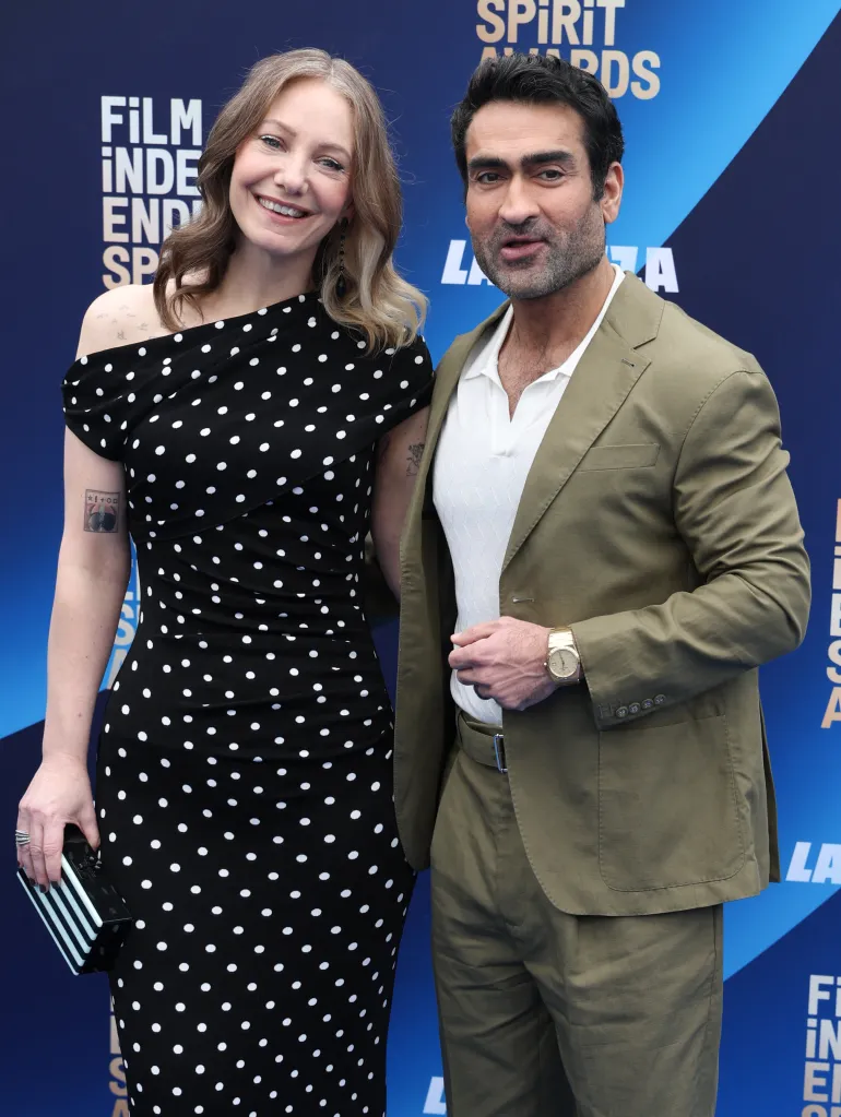 Kumail Nanjiani and Emily V. Gordon pose on the blue carpet at the Film Independent Spirit Awards.