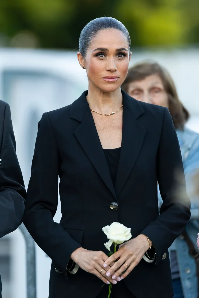 Meghan, Duchess of Sussex, holding a white rose during the inauguration of 'The Lost Screen Memorial' exhibition in Geneva.