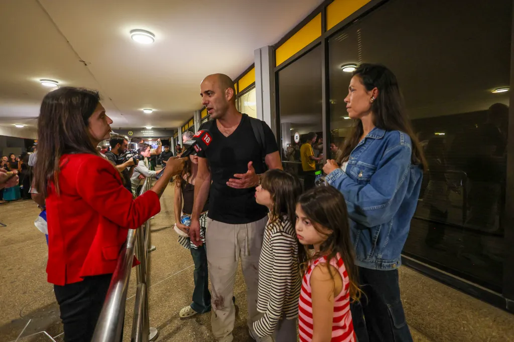 Passengers, including Tzvika Manes, are welcomed by their relatives at Ben Gurion Airport.