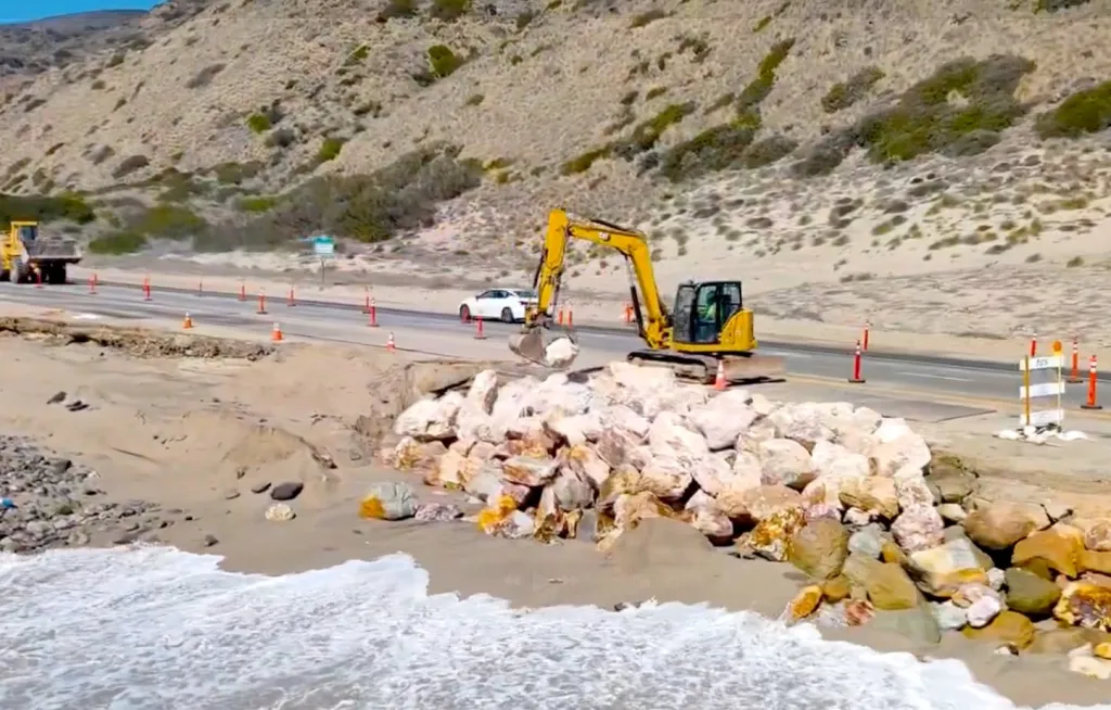 Construction crews building Rock Slope Protection along State Route 1 at Thornhill Broome Beach.