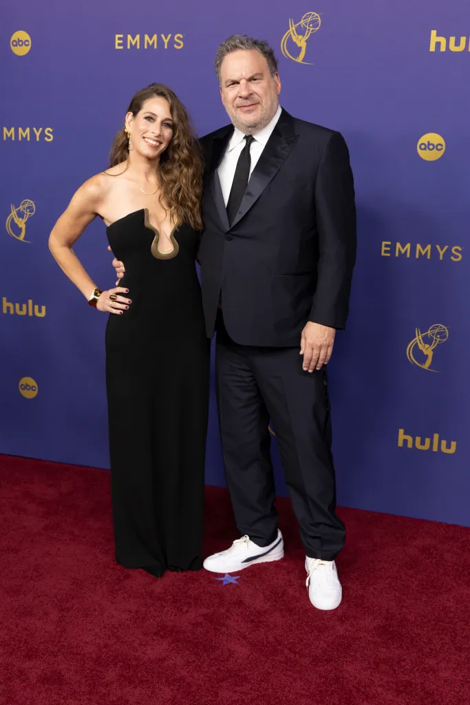 Sari Tracht and Jeff Garlin pose on the red carpet at the Emmy Awards.