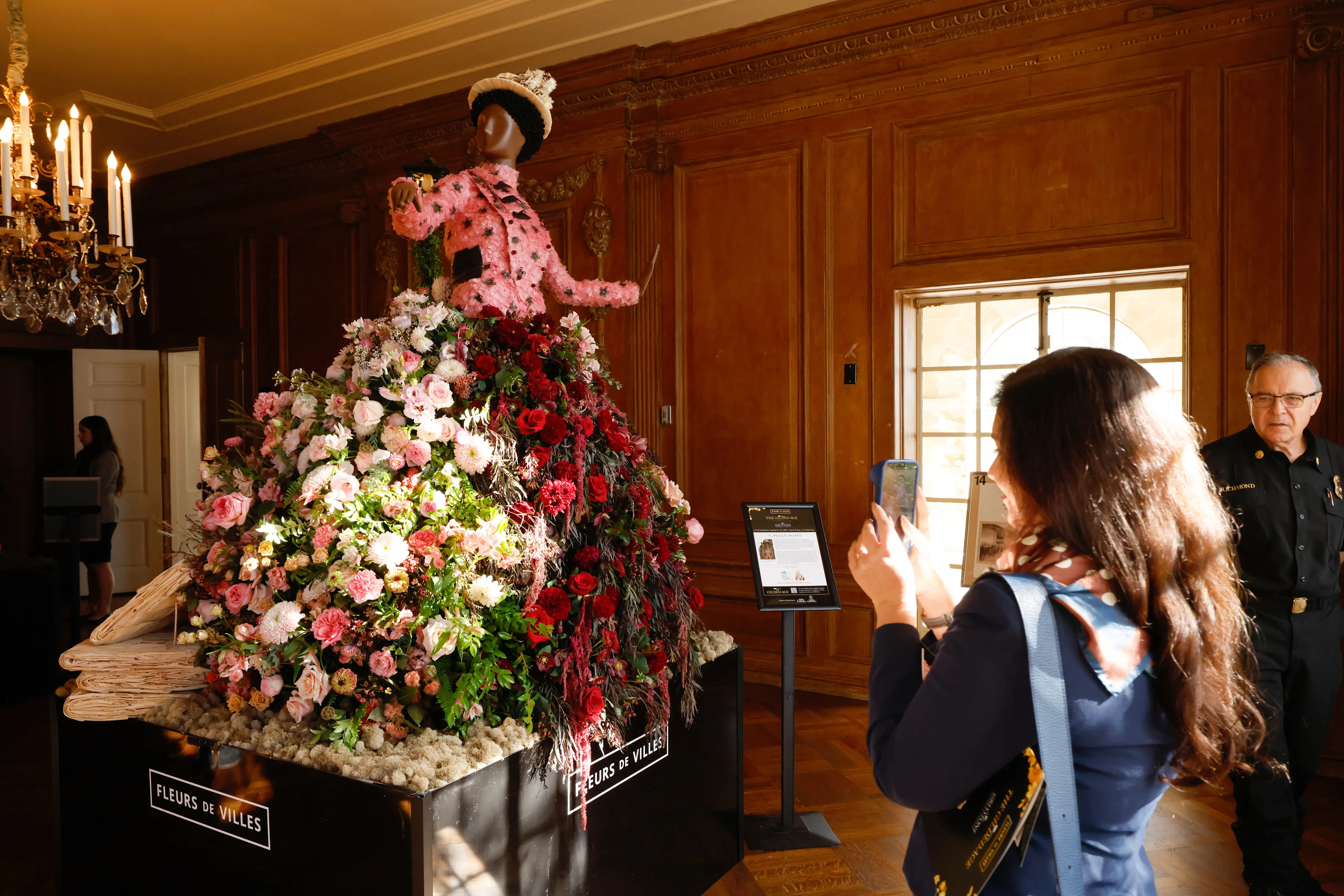 A visitor photographs a Peggy Scott flower sculpture at the 